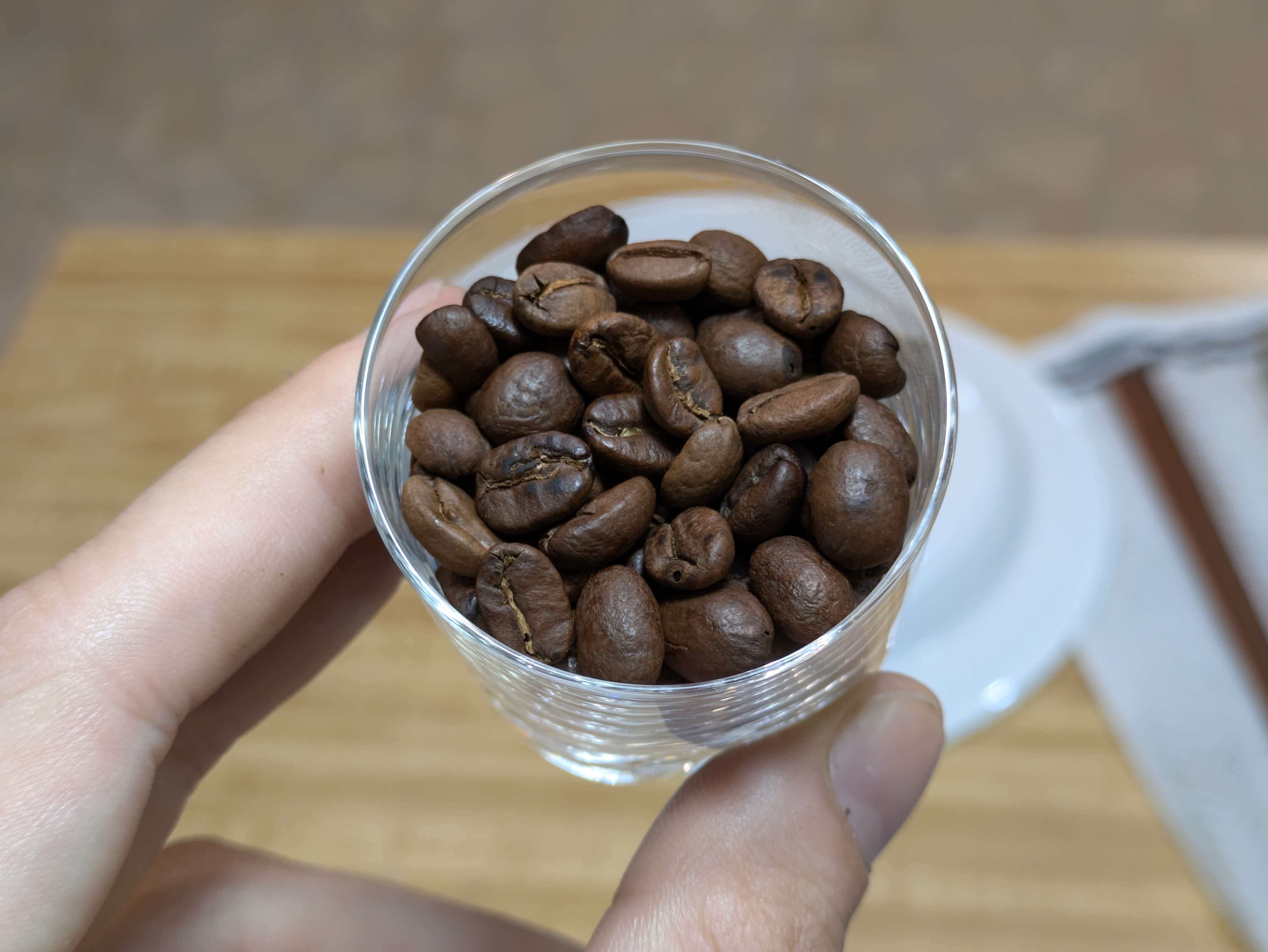 roasted coffee beans,
           held in a clear shot glass